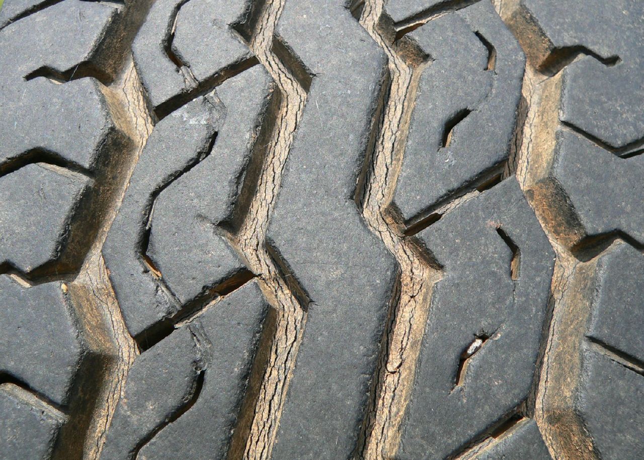 Worn tread blocks with cracked, shallow grooves between them